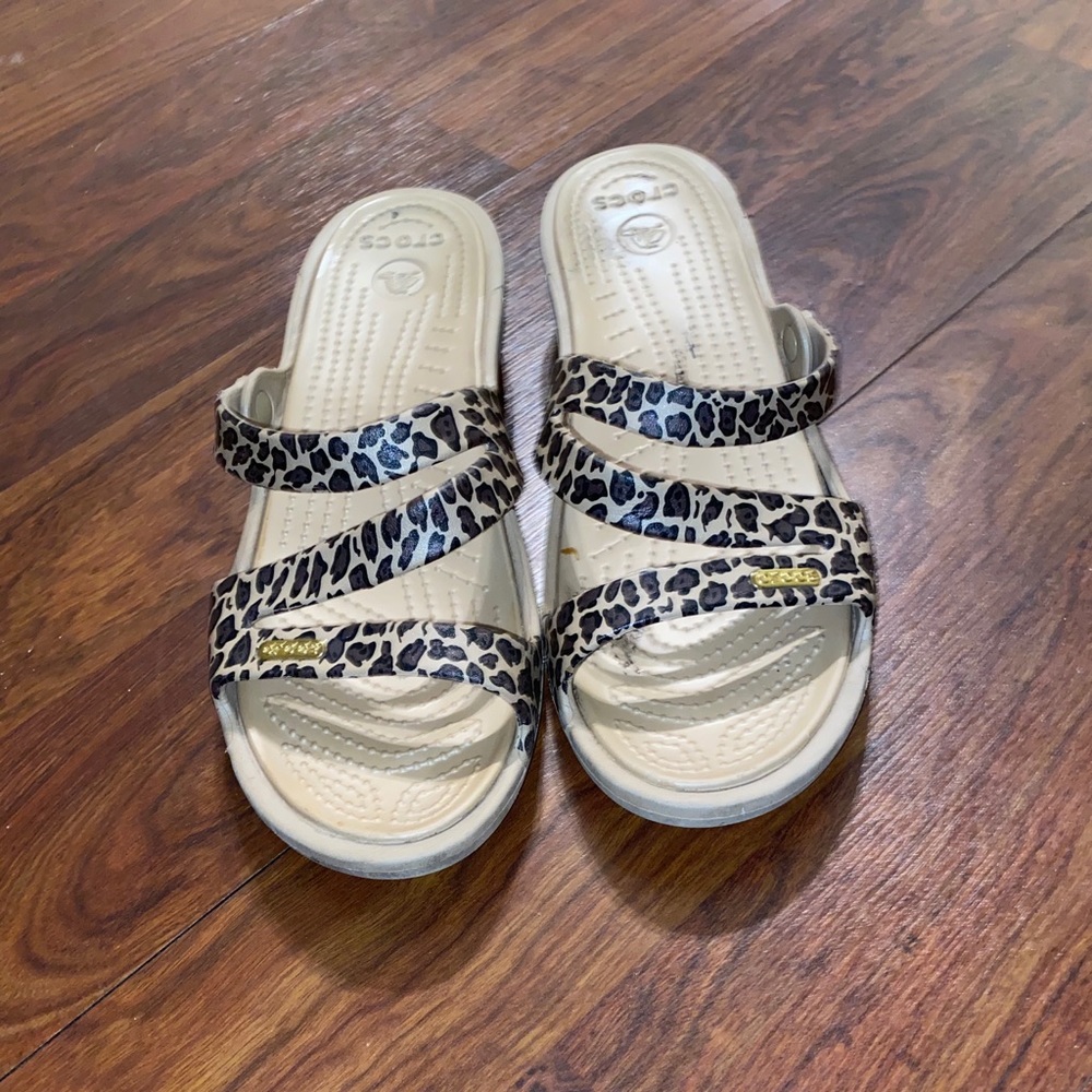 Crocs sandals for women with gold crocs logo.